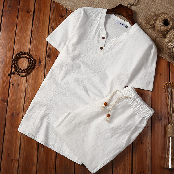 Cotton And Linen Two-piece Buckle Suit Casual V-neck Two-piece Set in white laid on wooden background.