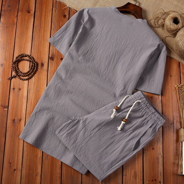 Cotton And Linen Two-piece Buckle Suit Casual V-neck Two-piece Set in gray color on wooden background.