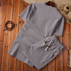 Cotton And Linen Two-piece Buckle Suit Casual V-neck Two-piece Set in gray color on wooden background.